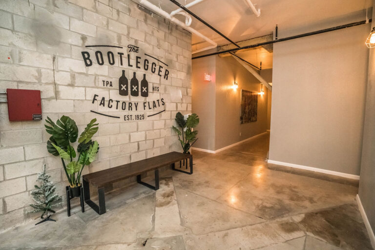 Bootlegger Flats lobby with property logo on wall